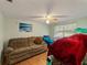 Bedroom with a sofa and a window bringing in natural light at 12202 Meadowbrook Ln, Hudson, FL 34667