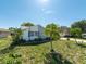 Well-kept lawn and shrubs frame this lovely single-story house with a stone accent wall at 12202 Meadowbrook Ln, Hudson, FL 34667