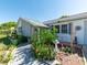 Well maintained home with decorative shrubs and flowers lining the walkway to the front door with a stone accent at 12202 Meadowbrook Ln, Hudson, FL 34667