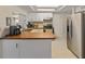 Well lit kitchen with stainless steel fridge and plenty of counter space at 12202 Meadowbrook Ln, Hudson, FL 34667