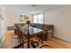 Relaxing living room area with a dark wood table, a large sectional couch, and a palm tree wall art piece at 12202 Meadowbrook Ln, Hudson, FL 34667