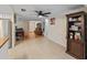Spacious living area featuring tile floors, an entertainment center, and a dining area at 12202 Meadowbrook Ln, Hudson, FL 34667