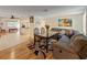 Open-concept living area featuring hardwood floors, a comfortable sectional sofa, and a dining set at 12202 Meadowbrook Ln, Hudson, FL 34667