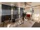 Bright sunroom with tile flooring, ceiling fan, and large windows with curtains at 12202 Meadowbrook Ln, Hudson, FL 34667
