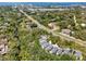 Aerial view of multiple two-story homes with a highway, water, and city in the distance highlighting the location at 1353 Curlew Rd, Dunedin, FL 34698