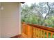 This cozy balcony features wood floors and railings, providing a perfect spot to enjoy the surrounding greenery at 1353 Curlew Rd, Dunedin, FL 34698