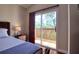 Bedroom with sliding glass door providing access to outdoor balcony at 1353 Curlew Rd, Dunedin, FL 34698