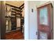 Walk-in closet with custom shelving and hardwood floors provides ample storage space at 1353 Curlew Rd, Dunedin, FL 34698