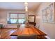 The dining room features a large window seat, modern lighting, and artistic decor creating a welcoming space at 1353 Curlew Rd, Dunedin, FL 34698