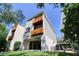 Upward exterior view of a multi-story home with two wooden balconies at 1353 Curlew Rd, Dunedin, FL 34698
