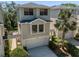 Charming two-story townhouse features a garage, landscaped yard and walkway with covered patio at 1353 Curlew Rd, Dunedin, FL 34698