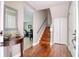 Foyer view showcasing hardwood floors, staircase, and an adjacent room at 1353 Curlew Rd, Dunedin, FL 34698