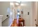 Bright hallway features wood flooring, neutral walls, and natural light from skylight at 1353 Curlew Rd, Dunedin, FL 34698