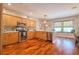 This kitchen features stainless appliances, wood cabinets, and a large window creating a warm and inviting space at 1353 Curlew Rd, Dunedin, FL 34698