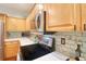 Bright kitchen features light wood cabinets, sleek countertops, a modern stainless steel oven and stunning tile backsplash at 1353 Curlew Rd, Dunedin, FL 34698