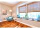 This living room features cozy seating by a large window, providing a tranquil retreat with natural light and style at 1353 Curlew Rd, Dunedin, FL 34698