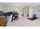 Spacious living room with a piano, office area and entry to a bathroom at 1353 Curlew Rd, Dunedin, FL 34698