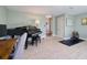 Spacious living room with a piano, office area and exercise machine at 1353 Curlew Rd, Dunedin, FL 34698