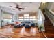 Spacious living room with hardwood floors, ceiling fan, and ample natural light at 1353 Curlew Rd, Dunedin, FL 34698