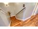 View of the staircase with wood steps and a hand rail, illuminated by overhead lighting at 1353 Curlew Rd, Dunedin, FL 34698