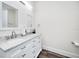 Bright bathroom features a double sink vanity with marble countertop and wooden floors at 1453 Otten St, Clearwater, FL 33755