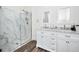 Modern bathroom features a walk-in shower with marble surround and double sink vanity at 1453 Otten St, Clearwater, FL 33755