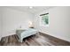 Cozy bedroom featuring a ceiling fan and a window that offers ample natural light at 1453 Otten St, Clearwater, FL 33755