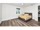 Comfortable bedroom offers hardwood floors, a ceiling fan, and a window with outdoor views at 1453 Otten St, Clearwater, FL 33755