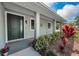 Inviting front entrance with a dark-green door, lush landscaping, and a welcoming porch at 1453 Otten St, Clearwater, FL 33755
