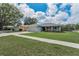 Attractive single-story home featuring an attached garage and a landscaped front yard at 1453 Otten St, Clearwater, FL 33755