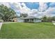 The well maintained front lawn showcases this delightful single Gathering home in daytime at 1453 Otten St, Clearwater, FL 33755
