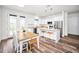 Eat-in kitchen features white cabinets, stainless steel appliances, and a dining area with backyard access at 1453 Otten St, Clearwater, FL 33755