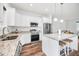 Open kitchen showcases stainless steel appliances, island with seating, and modern pendant lights at 1453 Otten St, Clearwater, FL 33755