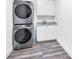 Efficient laundry area with stacked washer and dryer plus cabinets and sink at 1453 Otten St, Clearwater, FL 33755