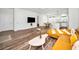 Spacious open-concept living area with hardwood floors, a comfortable sofa, and kitchen access at 1453 Otten St, Clearwater, FL 33755