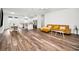 Open-concept living space with hardwood floors, a modern sofa, and a kitchen island at 1453 Otten St, Clearwater, FL 33755