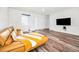 Bright living room featuring hardwood floors, a modern sofa, and neutral wall paint at 1453 Otten St, Clearwater, FL 33755