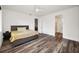 Spacious bedroom features hardwood floors, a ceiling fan, and access to an ensuite bathroom at 1453 Otten St, Clearwater, FL 33755