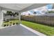 Enjoy the shaded, covered patio overlooking the grassy backyard, great for relaxing or entertaining at 1453 Otten St, Clearwater, FL 33755