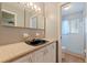 Bathroom featuring unique black sink basin, vanity with lots of cabinet space, and shower stall at 1572 84Th N Ave, St Petersburg, FL 33702