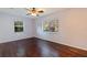 This bedroom features hardwood floors, natural light from the windows, and a ceiling fan at 1572 84Th N Ave, St Petersburg, FL 33702