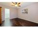 The bedroom features hardwood floors, natural light, a ceiling fan, and a closet for storage at 1572 84Th N Ave, St Petersburg, FL 33702