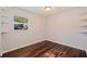Bedroom featuring hardwood floors, a window, and a shelf at 1572 84Th N Ave, St Petersburg, FL 33702
