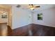 Bedroom with hardwood floors, natural light, ceiling fan, and a door leading to the backyard at 1572 84Th N Ave, St Petersburg, FL 33702