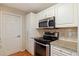 Kitchen featuring modern appliances, granite counters, and plenty of storage at 1572 84Th N Ave, St Petersburg, FL 33702