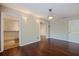 Bright living room with hardwood floors, a decorative light fixture, and open access to the kitchen and other rooms at 1572 84Th N Ave, St Petersburg, FL 33702