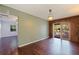 The living room features hardwood floors, a decorative light fixture, and access to the screened-in pool area at 1572 84Th N Ave, St Petersburg, FL 33702