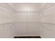 Spacious walk-in closet featuring white wire shelving and dark wood flooring at 1572 84Th N Ave, St Petersburg, FL 33702