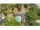 Aerial view of the home with a private pool and spacious yard at 1591 Chestnut W Ct, Palm Harbor, FL 34683