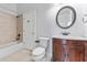 Full bathroom with wood vanity, and tiled shower and bathtub at 1591 Chestnut W Ct, Palm Harbor, FL 34683